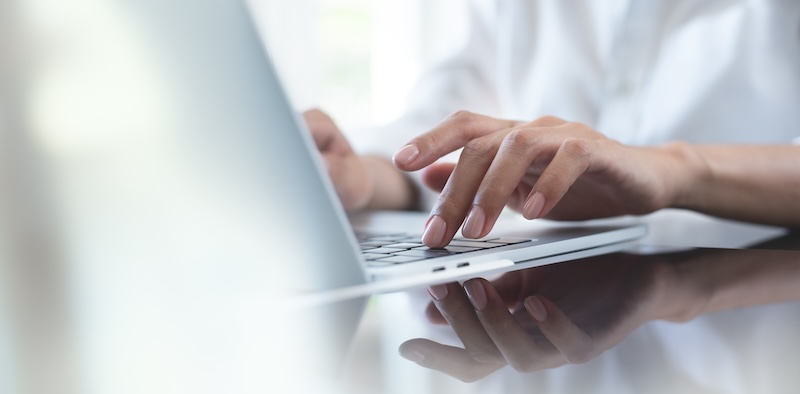 woman typing on laptop