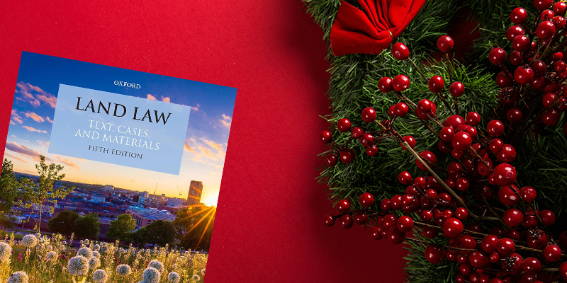 a land law book with a Christmas background