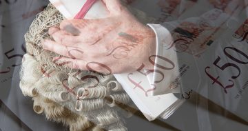 Close Up Of Barrister Holding Wig And Brief